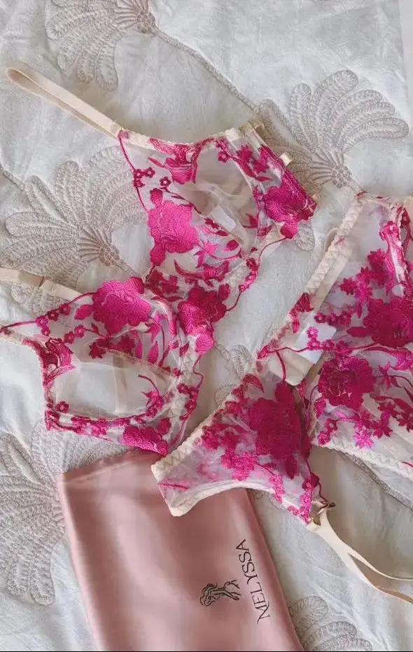 Floral lingerie set with a pink pouch on a textured fabric background